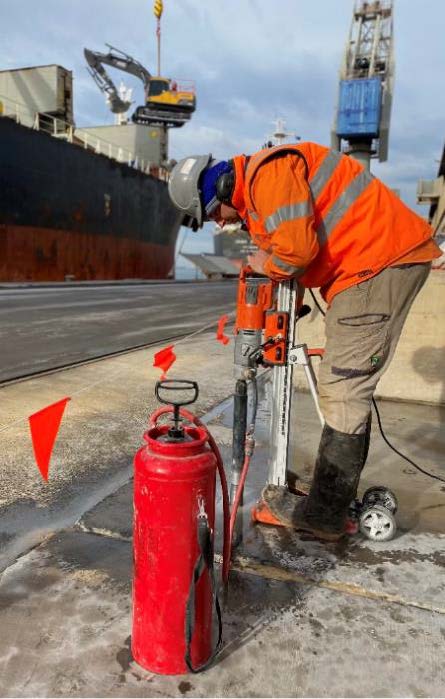 A worker drills concrete cores from the surface of the Lascelles Wharf, Australia, to perform independent testing. 